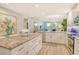 Open-concept kitchen with granite counters, white cabinets, and view into the living area at 8735 Olde Hickory Ave # 8205, Sarasota, FL 34238