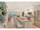 Bright, open kitchen with granite counters, stainless steel appliances, and a view into the living room at 8735 Olde Hickory Ave # 8205, Sarasota, FL 34238