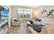 Comfortable living room featuring modern fireplace and seamless access to the screened lanai and beautiful landscape at 8735 Olde Hickory Ave # 8205, Sarasota, FL 34238