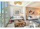 Living room with white sofas, wicker coffee table, and sliding doors leading to a screened patio at 8735 Olde Hickory Ave # 8205, Sarasota, FL 34238