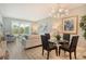 Inviting living room with sleek furnishings and a view of the green landscape beyond the large window at 8735 Olde Hickory Ave # 8205, Sarasota, FL 34238