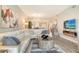 Bright living room with a sectional sofa, modern decor, and a view into the dining and kitchen areas at 8735 Olde Hickory Ave # 8205, Sarasota, FL 34238
