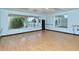 Bright studio space featuring hardwood floors, large windows, and wall-mounted ballet bar at 8735 Olde Hickory Ave # 8205, Sarasota, FL 34238