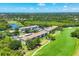 Aerial shot featuring condo buildings nestled near a golf course and lush greenery for a serene living environment at 8755 Olde Hickory Ave # 7105, Sarasota, FL 34238