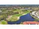 Beautiful aerial view of a well-manicured golf course, sand traps, and a scenic pond surrounded by lush trees at 8755 Olde Hickory Ave # 7105, Sarasota, FL 34238