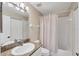 Bathroom featuring a tub shower with shower curtain, granite vanity, and tiled floors at 8755 Olde Hickory Ave # 7105, Sarasota, FL 34238