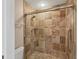 Bathroom features a tiled shower with glass door and grab bars for accessibility at 8755 Olde Hickory Ave # 7105, Sarasota, FL 34238