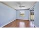 Bedroom with hardwood floors, ceiling fan, and sliding glass doors leading to a patio at 8755 Olde Hickory Ave # 7105, Sarasota, FL 34238
