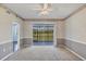 Well-lit bedroom features neutral carpet, gray accent wall, and a large sliding door with view at 8755 Olde Hickory Ave # 7105, Sarasota, FL 34238