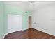 Bedroom with hardwood floors, closet and open door leading to another room at 8755 Olde Hickory Ave # 7105, Sarasota, FL 34238