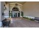 The clubhouse entrance boasts a covered entryway with brick pavers and benches at 8755 Olde Hickory Ave # 7105, Sarasota, FL 34238