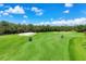 Beautiful golf course on a sunny day featuring lush greens and sand traps, perfect for a relaxing round of golf at 8755 Olde Hickory Ave # 7105, Sarasota, FL 34238