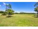 Picturesque view of a golf course showcasing lush green grass and mature trees at 8755 Olde Hickory Ave # 7105, Sarasota, FL 34238