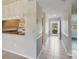 View of hallway with tile floor, and kitchen with wooden cabinets and granite countertops at 8755 Olde Hickory Ave # 7105, Sarasota, FL 34238