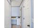 Hallway featuring a granite-topped vanity and ample storage space at 8755 Olde Hickory Ave # 7105, Sarasota, FL 34238