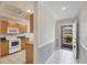 Kitchen with white appliances, wooden cabinets, and tile floor near the front door at 8755 Olde Hickory Ave # 7105, Sarasota, FL 34238