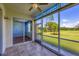 Screened lanai with tile flooring and golf course views at 8755 Olde Hickory Ave # 7105, Sarasota, FL 34238