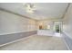 Bright living room features neutral carpet and gray accent wall with view into the kitchen at 8755 Olde Hickory Ave # 7105, Sarasota, FL 34238