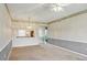 Spacious living room with view to kitchen and a tile floor hallway to exterior door at 8755 Olde Hickory Ave # 7105, Sarasota, FL 34238