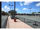 Well-maintained community tennis courts featuring a shaded pavilion, benches, and manicured landscaping at 8755 Olde Hickory Ave # 7105, Sarasota, FL 34238