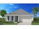 Charming one-story home featuring a two-car garage, well-manicured lawn, and lush landscaping at 9164 Florida Rock Trl, Sarasota, FL 34240