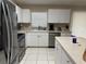 Bright kitchen featuring white cabinets, stainless steel appliances, and functional countertop space at 10116 Reagan Dairy Trl, Bradenton, FL 34212