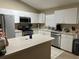 Well-lit kitchen featuring white cabinets, stainless steel appliances, and ample counter space at 10116 Reagan Dairy Trl, Bradenton, FL 34212