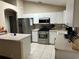 Spacious kitchen offering white cabinets, stainless steel appliances, and a convenient center island at 10116 Reagan Dairy Trl, Bradenton, FL 34212