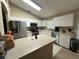 Bright kitchen with white cabinets, stainless steel appliances, and a functional center island at 10116 Reagan Dairy Trl, Bradenton, FL 34212