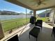 Relaxing screened patio with ceiling fan and outdoor furniture, perfect for enjoying the backyard view at 10116 Reagan Dairy Trl, Bradenton, FL 34212