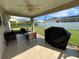 Relaxing covered patio with comfortable seating, ceiling fan, and views of the landscaped yard at 10116 Reagan Dairy Trl, Bradenton, FL 34212
