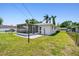 Spacious backyard featuring a screened patio and chain link fence is great for enjoying the Florida lifestyle at 1200 25Th W Ave, Palmetto, FL 34221