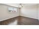 This bedroom features wood floors, a ceiling fan, and natural light from the window at 1200 25Th W Ave, Palmetto, FL 34221