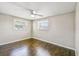 This bedroom features wood floors, ceiling fan, and natural light from the two windows at 1200 25Th W Ave, Palmetto, FL 34221