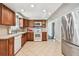 Traditional kitchen featuring wood cabinets, white appliances, tiled flooring, and ample counter space at 1200 25Th W Ave, Palmetto, FL 34221