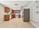 Updated kitchen featuring wood cabinets, white appliances, and tile flooring offers a functional and stylish design at 1200 25Th W Ave, Palmetto, FL 34221