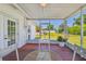 Enjoy the outdoors on this screened patio with outdoor furniture and views of the backyard at 1200 25Th W Ave, Palmetto, FL 34221