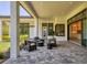 This spacious covered patio features brick pavers and comfortable seating for entertaining guests at 12005 Trails Reserve Ct, Sarasota, FL 34238