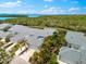 Aerial view of multiple homes with gray roofs, driveways, landscaping and water views at 1312 Perico Point Cir, Bradenton, FL 34209