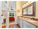 Bathroom with double sinks and views into the bedroom at 1312 Perico Point Cir, Bradenton, FL 34209