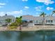 Back exterior of house with waterfront location, showing deck and mature landscaping at 1312 Perico Point Cir, Bradenton, FL 34209