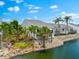 A beautiful view of the rear exterior, showing deck, landscaping, and waterfront at 1312 Perico Point Cir, Bradenton, FL 34209