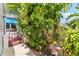 This is a beautiful garden shot showcasing the lush greenery of various plants and trees along the side of the home at 1312 Perico Point Cir, Bradenton, FL 34209