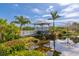 A picturesque gazebo set by a pond offers a peaceful retreat surrounded by lush greenery at 1312 Perico Point Cir, Bradenton, FL 34209