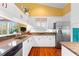 Bright kitchen with white cabinets, stainless steel appliances, granite countertops, and hardwood flooring at 1312 Perico Point Cir, Bradenton, FL 34209