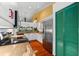 Beautiful kitchen with white cabinets, granite countertops, stainless steel appliances, and a green door at 1312 Perico Point Cir, Bradenton, FL 34209