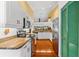 Well-lit kitchen featuring white cabinets, granite countertops, stainless steel appliances, and hardwood flooring at 1312 Perico Point Cir, Bradenton, FL 34209