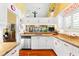 Bright kitchen with white cabinets, stainless steel appliances, and a granite countertop, perfect for culinary adventures at 1312 Perico Point Cir, Bradenton, FL 34209