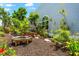Lush landscaped yard with a bench and custom seating area next to the home at 1312 Perico Point Cir, Bradenton, FL 34209