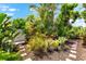 Professionally landscaped yard with stone path and mature tropical plants at 1312 Perico Point Cir, Bradenton, FL 34209